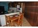 A wood table for four sits adjacent to a living room with a white couch at 7219 Williams S Dr, St Petersburg, FL 33705