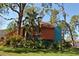 Stunning home with unique architecture, beautiful landscaping, and mature trees creating a lush, natural setting at 7219 Williams S Dr, St Petersburg, FL 33705