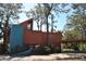 Unique home featuring a modern design, a cylindrical tower, and a convenient carport, all surrounded by mature trees at 7219 Williams S Dr, St Petersburg, FL 33705