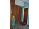 Unique foyer featuring wood wall, turquoise paint, and brick floor at 7219 Williams S Dr, St Petersburg, FL 33705