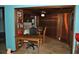 A living space with a desk, table, seating, shelves, and unique wood paneled walls at 7219 Williams S Dr, St Petersburg, FL 33705