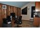 Charming office space with wood cabinets, modern desk, and unique window at 7219 Williams S Dr, St Petersburg, FL 33705