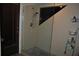 Shower room featuring stylish pebble floor, glass door, and convenient shelving units at 7219 Williams S Dr, St Petersburg, FL 33705