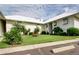 Condo exterior with lush green lawn and mature landscaping at 7310 Sunshine Skyway S Ln # 219, St Petersburg, FL 33711