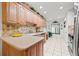 Bright kitchen featuring granite countertops, stainless steel appliances, and custom backsplash at 7310 Sunshine Skyway S Ln # 219, St Petersburg, FL 33711
