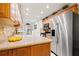 Updated kitchen with stainless steel appliances, granite countertops, and warm wood cabinets at 7310 Sunshine Skyway S Ln # 219, St Petersburg, FL 33711