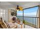 Screened lanai with beautiful water views, a ceiling fan, and comfortable seating at 7310 Sunshine Skyway S Ln # 219, St Petersburg, FL 33711