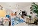 Open concept living room with ceiling fan, fireplace, and view into kitchen at 7310 Sunshine Skyway S Ln # 219, St Petersburg, FL 33711