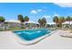 Community pool surrounded by lounge chairs and palm trees at 7310 Sunshine Skyway S Ln # 219, St Petersburg, FL 33711