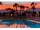 Community pool at sunset with palm trees and building reflections in the water at 7310 Sunshine Skyway S Ln # 219, St Petersburg, FL 33711