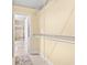 Spacious walk-in closet with open doorway to bathroom and white shelving at 7310 Sunshine Skyway S Ln # 219, St Petersburg, FL 33711