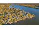 Aerial view of waterfront homes along a river with lush trees and blue skies at 8841 W Millpoint Rd, Riverview, FL 33578