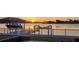 Home's backyard with boat lift, dock, covered boat, and waterfront views at 8841 W Millpoint Rd, Riverview, FL 33578