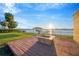 Waterfront backyard with a fire pit, deck, and stunning views, ideal for outdoor gatherings at 8841 W Millpoint Rd, Riverview, FL 33578
