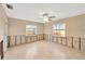 Bright bedroom with a ceiling fan and two windows at 8841 W Millpoint Rd, Riverview, FL 33578