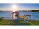 Waterfront dock featuring a boat lift, perfect for fishing and boating, with stunning water views at 8841 W Millpoint Rd, Riverview, FL 33578