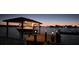Boat on a lift at the dock of this waterfront property at twilight at 8841 W Millpoint Rd, Riverview, FL 33578