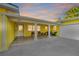 Exterior of yellow home with a white door, white pillars, plants, and a two-car garage at 8841 W Millpoint Rd, Riverview, FL 33578