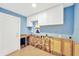 Bright room with white cabinets, window, and a door on the left at 8841 W Millpoint Rd, Riverview, FL 33578