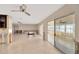 Open living room featuring tile floors, ceiling fan, and views through glass patio doors at 8841 W Millpoint Rd, Riverview, FL 33578