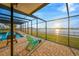 Enjoy outdoor living with this screened-in pool and patio overlooking the water at 8841 W Millpoint Rd, Riverview, FL 33578