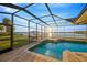 Sparkling pool with a hot tub and screened-in enclosure overlooking waterfront at 8841 W Millpoint Rd, Riverview, FL 33578