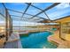 Beautiful pool with spa inside a screened enclosure with waterfront views and seating at 8841 W Millpoint Rd, Riverview, FL 33578