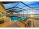 Screened in pool and patio area with furniture, perfect for relaxing and enjoying the view at 8841 W Millpoint Rd, Riverview, FL 33578