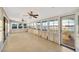 Sunroom featuring tile floor, windows with views of water, and ceiling fans at 8841 W Millpoint Rd, Riverview, FL 33578