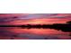 Waterfront property featuring a striking sunset reflected in calm water, providing a serene view at 8841 W Millpoint Rd, Riverview, FL 33578