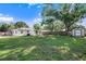 Expansive backyard with green lawn, wood fence, shed, and mature trees at 917 2Nd Nw Ave, Largo, FL 33770