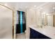 Clean bathroom features a glass-enclosed shower and large vanity with a framed mirror at 917 2Nd Nw Ave, Largo, FL 33770