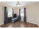 Neutral bedroom with gray curtains, wood-look floors, and natural light at 917 2Nd Nw Ave, Largo, FL 33770