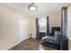 Neutral bedroom with gray curtains, closet, wood-look floors, and natural light at 917 2Nd Nw Ave, Largo, FL 33770
