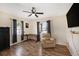 Relaxing room showcasing wood-look floors, ceiling fan, and comfortable recliner at 917 2Nd Nw Ave, Largo, FL 33770