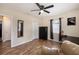 Bright room featuring wood-look floors, black dresser, and dark window coverings at 917 2Nd Nw Ave, Largo, FL 33770