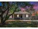 Charming home with lush landscaping, mature trees, shutters, and colorful sunset at 917 2Nd Nw Ave, Largo, FL 33770