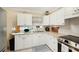 Well-maintained kitchen with white cabinets and updated appliances, offering a clean and efficient space at 917 2Nd Nw Ave, Largo, FL 33770