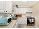 Bright and clean kitchen featuring white cabinetry and modern appliances for a functional cooking space at 917 2Nd Nw Ave, Largo, FL 33770