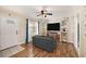 Cozy living room with hardwood floors, a comfortable couch, and stylish shelving at 917 2Nd Nw Ave, Largo, FL 33770