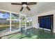 Enclosed sun room with ceiling fan, and sliding glass windows leading to fenced backyard at 917 2Nd Nw Ave, Largo, FL 33770