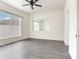 Bedroom featuring ceiling fan, window and mirror, with wood-look flooring at 10138 Mowry Ln, Tampa, FL 33625