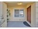 Inviting home entrance featuring a secure brown door, bright window, and ambient lighting at 10711 Keys Gate Dr, Riverview, FL 33579