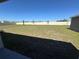 Expansive backyard featuring healthy grass and a pristine white fence, perfect for outdoor activities at 11517 Timber Grove Ln, Brooksville, FL 34613