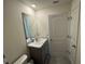 Bathroom with a vanity, sink, mirror, and tiled flooring, combining functionality with contemporary design at 11517 Timber Grove Ln, Brooksville, FL 34613
