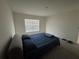Bedroom featuring a comfortable bed, window with blinds and neutral walls, creating a relaxing and inviting space at 11517 Timber Grove Ln, Brooksville, FL 34613