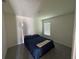 Simple bedroom with neutral carpet, queen bed, and window providing natural light at 11517 Timber Grove Ln, Brooksville, FL 34613