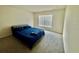 Well-lit bedroom featuring soft carpet, a comfortable queen bed, and a window offering ample light at 11517 Timber Grove Ln, Brooksville, FL 34613