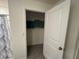 Bathroom closet with an open door and view of neutral colored towels at 11517 Timber Grove Ln, Brooksville, FL 34613