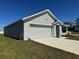 Well-maintained, single-story home shows simple landscaping and an attached two car garage at 11517 Timber Grove Ln, Brooksville, FL 34613